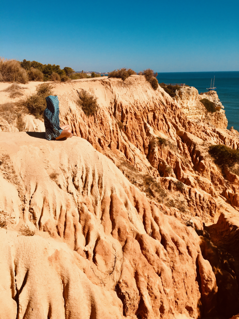 Growth Adventure, woman sitting next to sea